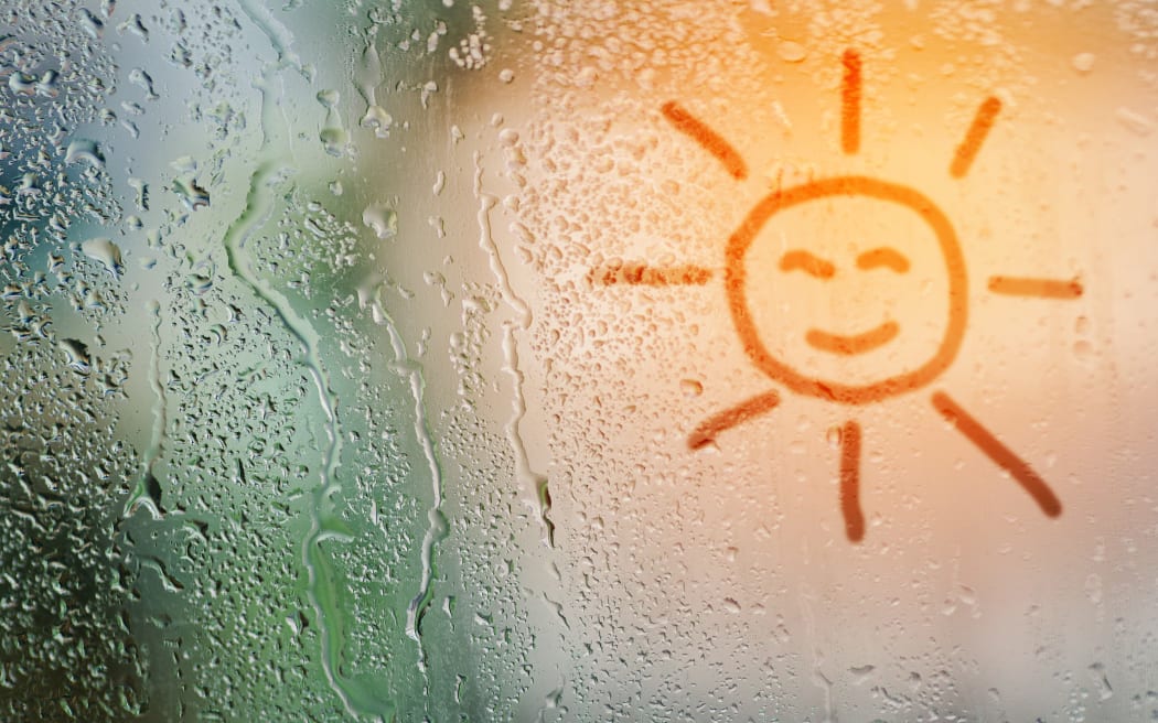 draw sun on natural water drops glass window background