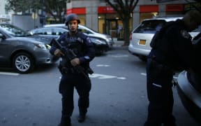 An armed officer at the scene of the truck attack.