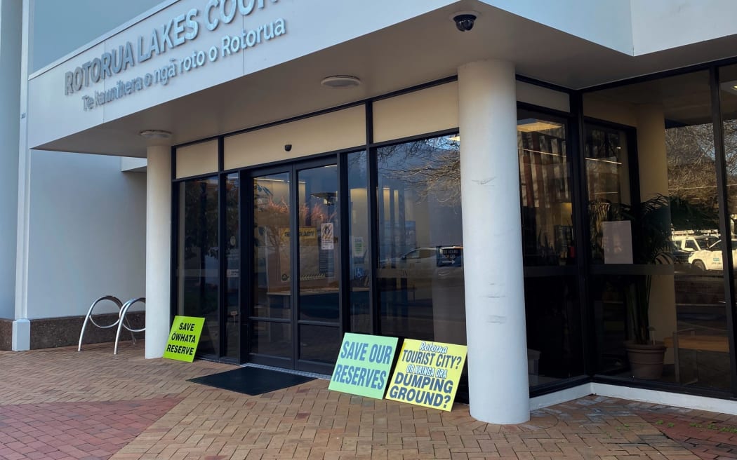 Signs outside Rotorua District Council over possible sale of reserves