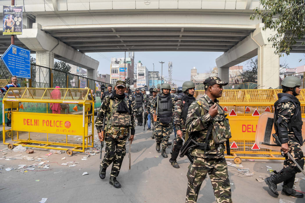 Security personnel patrol on a street following clashes between people supporting and opposing a contentious amendment to India's citizenship law, in New Delhi on February 26, 2020.