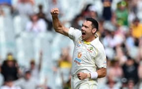 Scott Boland of Australia celebrates.