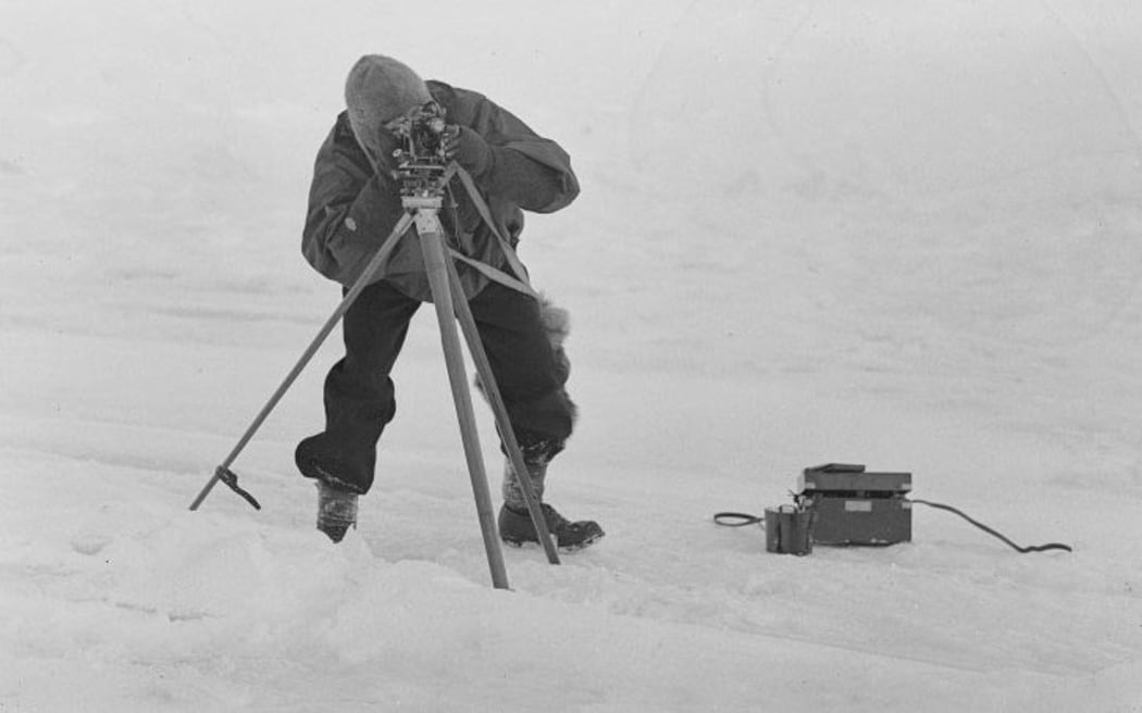 Lieutenant Victor Campbell surveys with a theodolite.