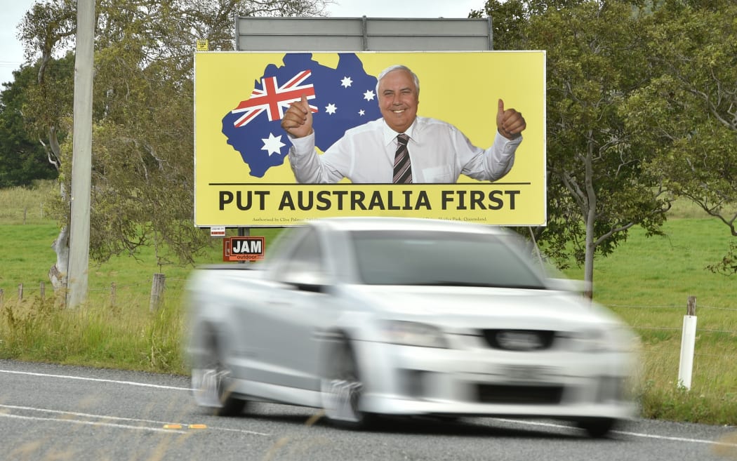 Photo taken on May 3, 2019 shows a ute driving past an election sign for mining magnate Clive Palmer's United Australia Party in Bowen in northern Queensland.