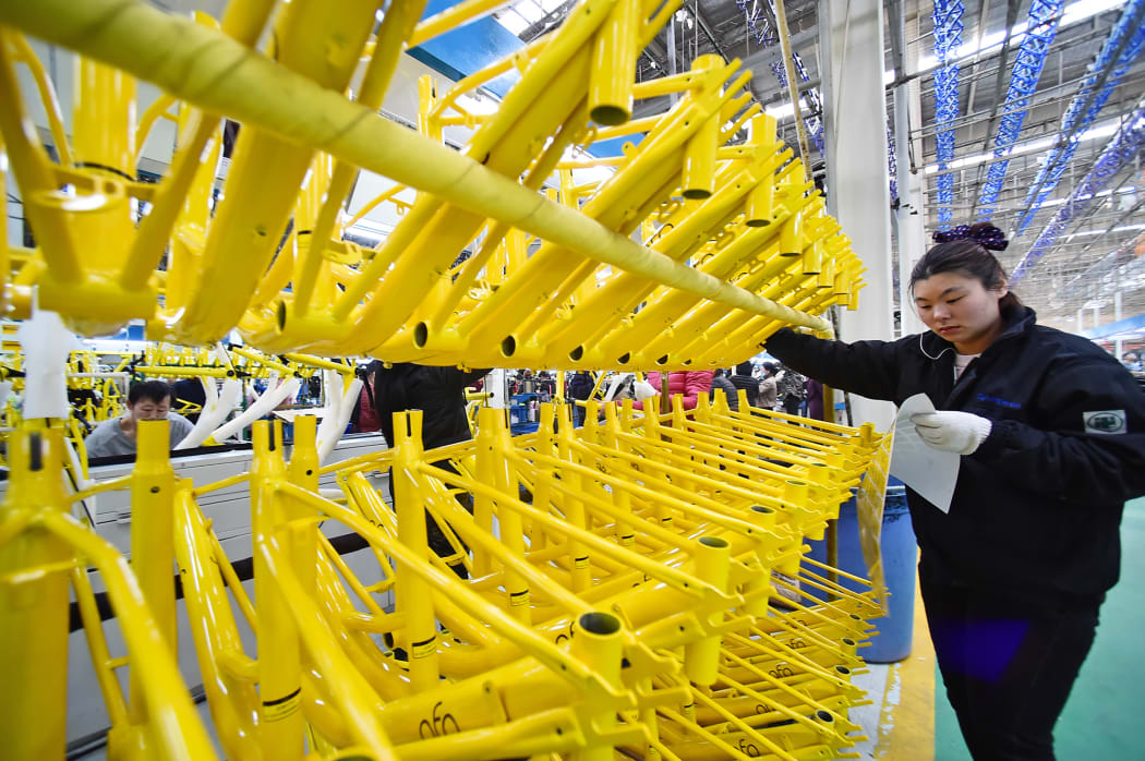 A worker prepares parts for bicycles of Chinese bike sharing service Ofo at a factory in Tianjin, China, 16 March 2017