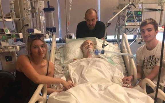 New Zealand mother Abby Hartley in a Bali Hospital with her children, Sophie and Toby, and husband, Richard.
