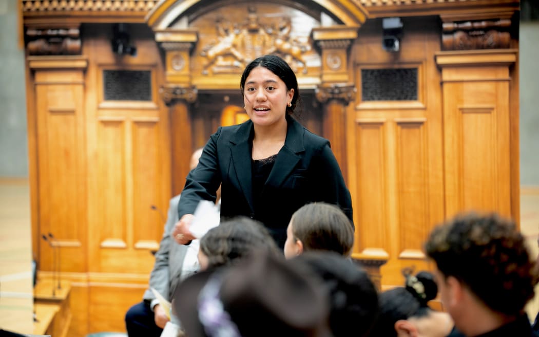 A student role-playing as the leader of the Opposition makes her case during the mock debate.