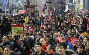 People react after hearing the Constitutional Court's verdict during a rally calling for impeachment of President Park Geun-hye near the Constitutional Court in Seoul, South Korea.