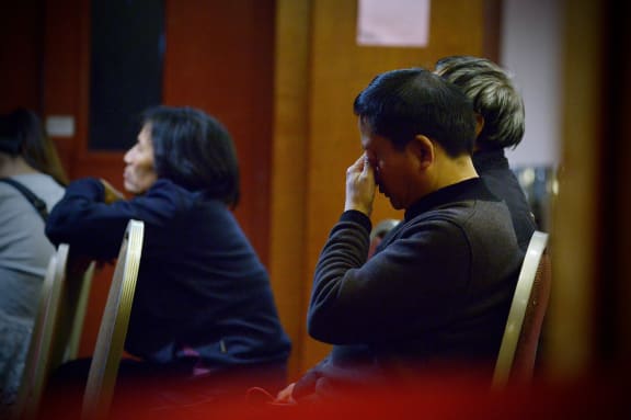 Relatives of missing passengers wait for new information at a Beijing hotel on Tuesday.