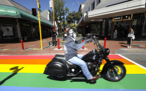 A motorcyclist rides over the new rainbow crossing in Wellington.