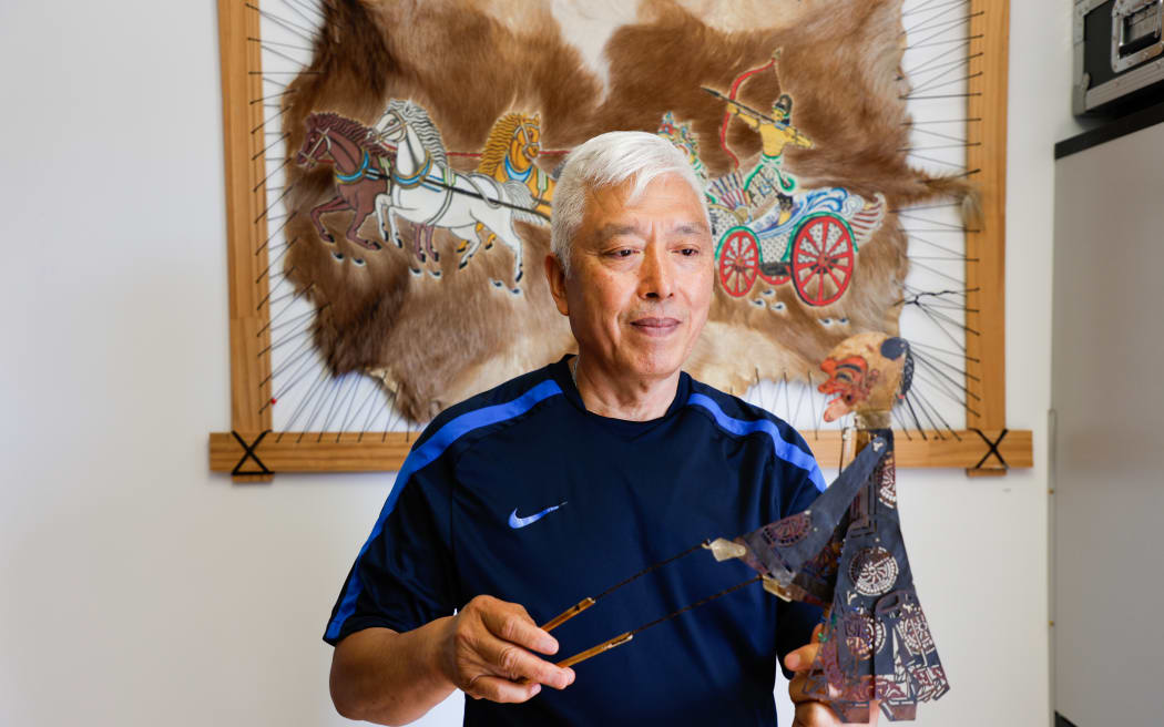 William Hou displays one of his Chinese shadow puppet collections, dating back to the Qing Dynasty.