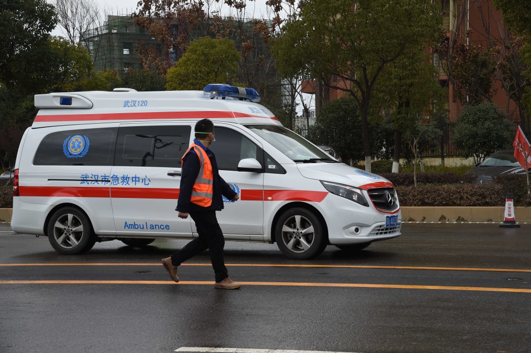 An ambulance carrying coronavirus patients arrives at a hospital in Wuhan, Feb 8 2020.