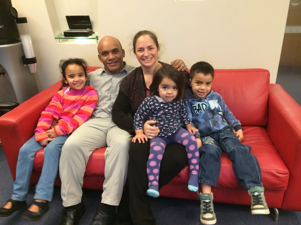 Roland Kun with his family at the RNZ studio in Wellington, New Zealand.