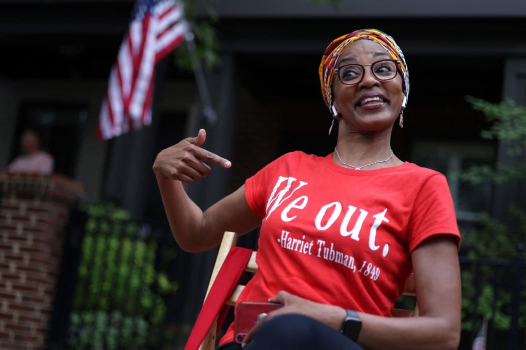 Janice Lloyd points to a quote that reads "We out" on her T-shirt as she watches a parade to celebrate Juneteenth in Annapolis, Maryland.