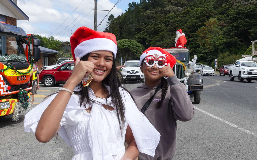 Christmas elf Kaira King, 14, left, had the all-important job of distributing lollies to children along the route.