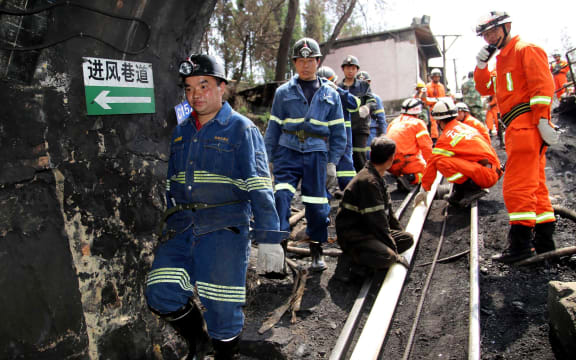 Rescuers make their way into the Xiahaizi mine shaft.
