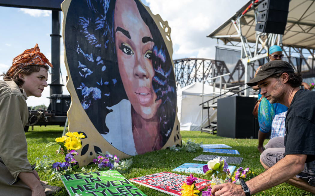 LOUISVILLE, KY - JUNE 05: Protesters and volunteers prepare a Breonna Taylor art installation by laying posters and flowers before the "Praise in the Park" event at the Big Four Lawn on June 5, 2021 in Louisville, Kentucky. The event commemorated what would have been Breonna Taylor’s 28th birthday. Taylor was a Black woman killed by police during a botched drug raid on her apartment on March 13, 2020, which sparked nationwide protests.   Jon Cherry/Getty Images/AFP (Photo by Jon Cherry / GETTY IMAGES NORTH AMERICA / Getty Images via AFP)