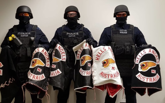 Some members of New South Wales Police's Strike Force Raptor team, with gang members' jackets.