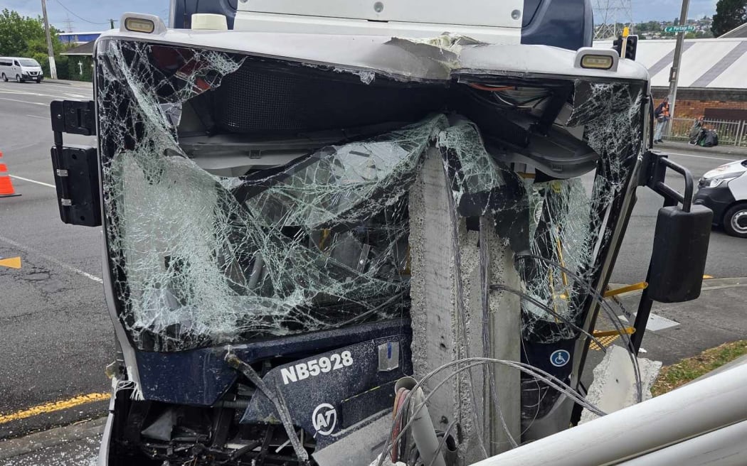 A bus has collided with a power pole in New Lynn, causing damage to Green Bay Auctions.
