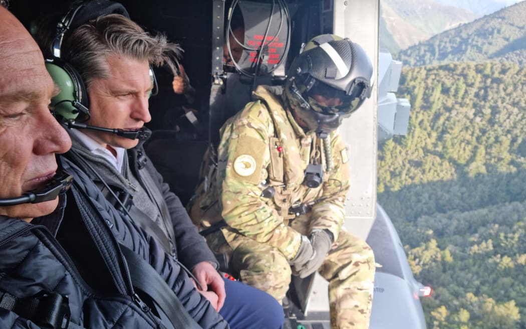Marlborough roads manager Steve Murrin and Transport Minister Michael Wood survey the road network in the Marlborough Sounds from the air on 1 September, 2022, after flooding in August caused damages.