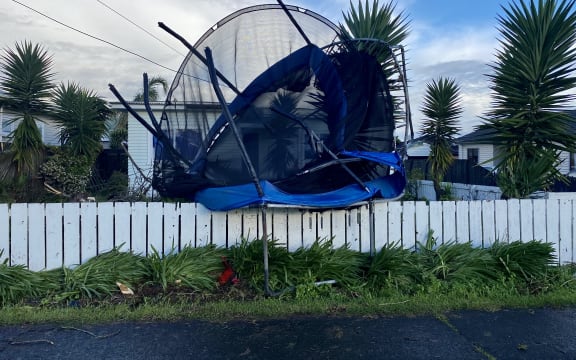 The tornado threw this trampoline on to a fence
