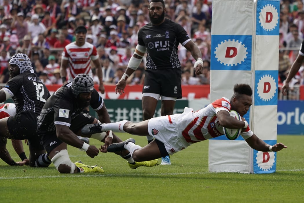 Japan's Kotaro Matsushima scores as his side defeats Fiji 34-21 at Kamaishi Recovery Memorial Stadium