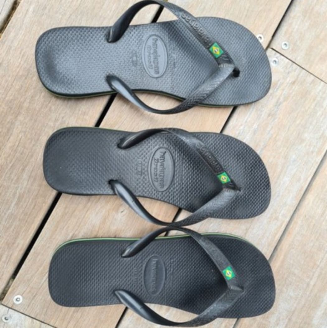 The three left-footed jandals on auction.