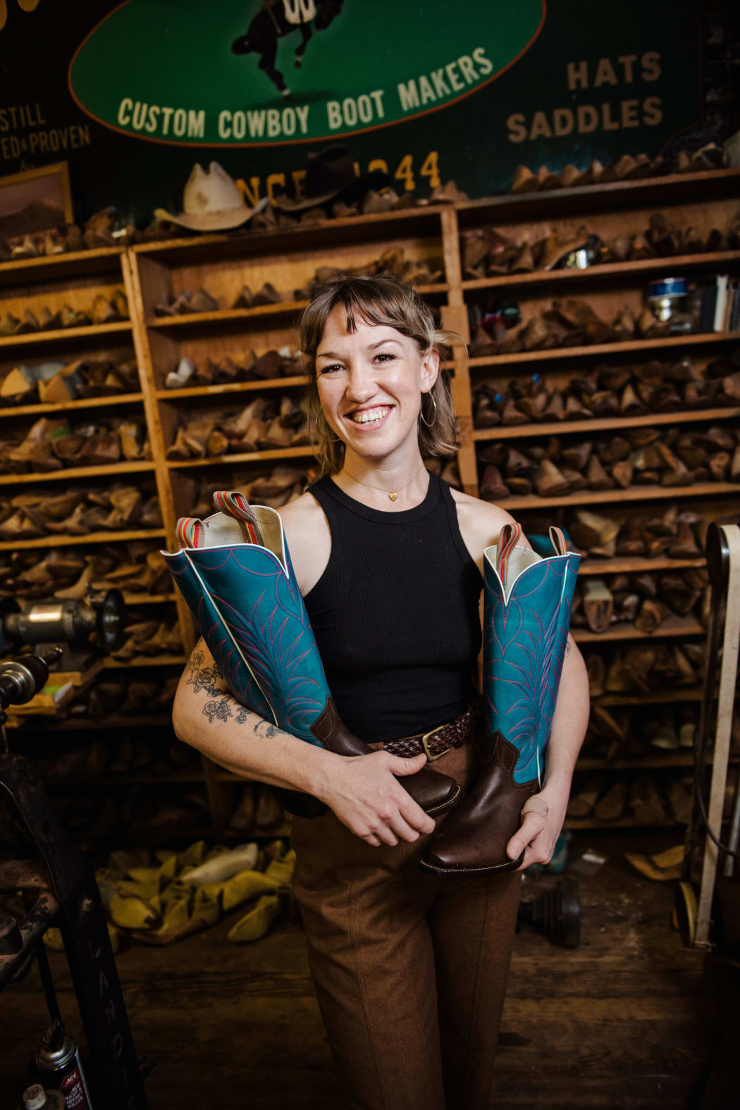 Flora holding a pair of Cowboy Boots