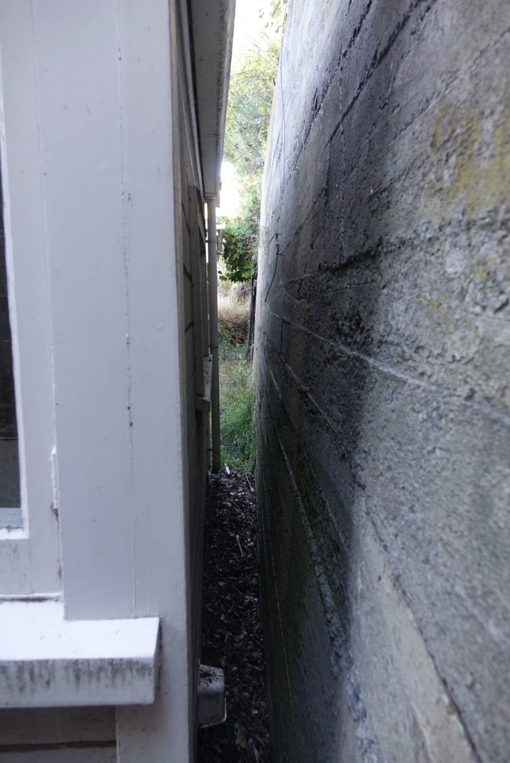 A retaining wall once 1.5 metres away moves to within a few centimetres of the house.