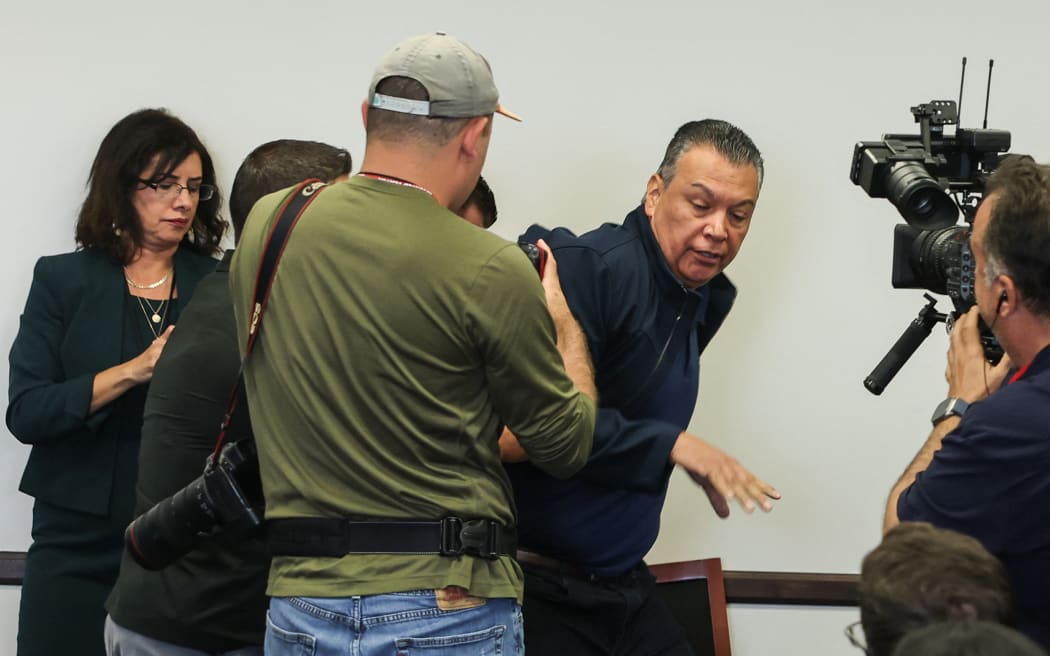 US Senator Alex Padilla, Democrat from California, is removed from the room after interrupting a news conference with Department of Homeland Security Secretary Kristi Noem at the Wilshire Federal Building in Los Angeles on June 12, 2025. US President Donald Trump said Thursday that Los Angeles was "safe and sound" for the past two nights, crediting his deployment of thousands of troops to quell anti-deportation protests, as California prepared for a legal showdown over his unprecedented move. With protests spreading across the United States, a night-time curfew has been in place in its second-largest city with authorities tackling vandalism and looting that scarred a few city blocks. (Photo by Patrick T. Fallon / AFP) / ALTERNATE CROP