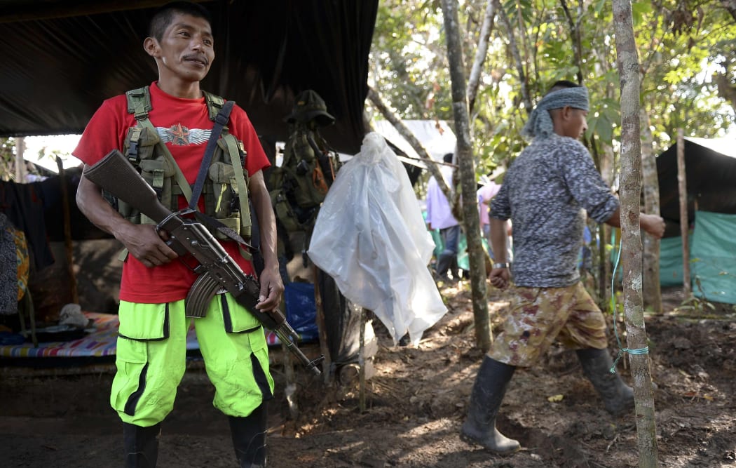 A member of the Colombian Revolutionary Armed Forces of Colombia (FARC) guerrilla, keeps watch at their camp in El Diamante, Caqueta Department, Colombia, on September 26, 2016