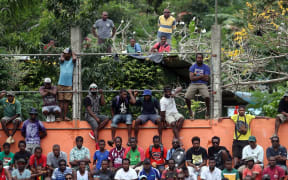 Vanuatu football fans find a vantage point in Port Vila.