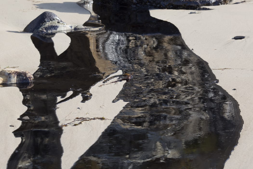 Oil flows towards the ocean after an inland oil pipeline ruptured in southern California.