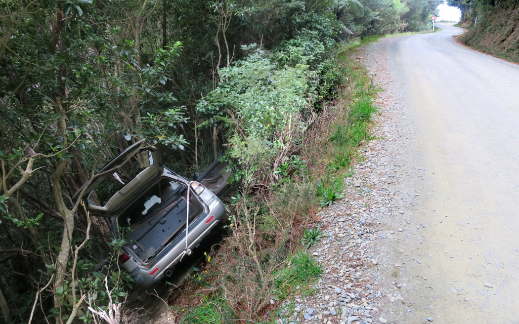 A wrecked vehicle off Port Underwood Rd in 2018. A new report says safety needs to be improved on key Marlborough Sounds routes