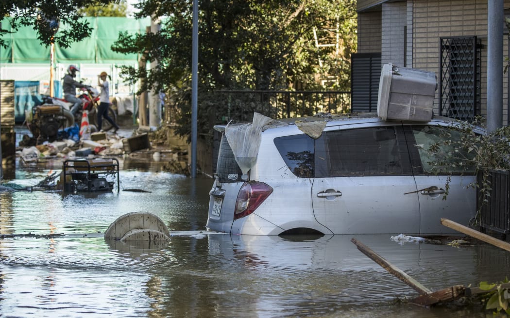Flooded vehicles are seen in the aftermath of Typhoon Hagibis in Kawasaki on October 13, 2019. -