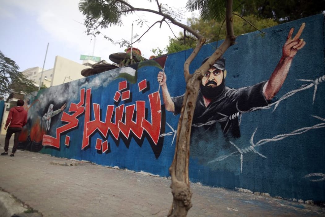 A picture taken on January 4, 2018, shows a mural of Ibrahim Abu Thurayeh, who was shot dead in clashes between Israeli forces and protesters along the Gaza-Israel border in December.
painted on a wall in Gaza City.