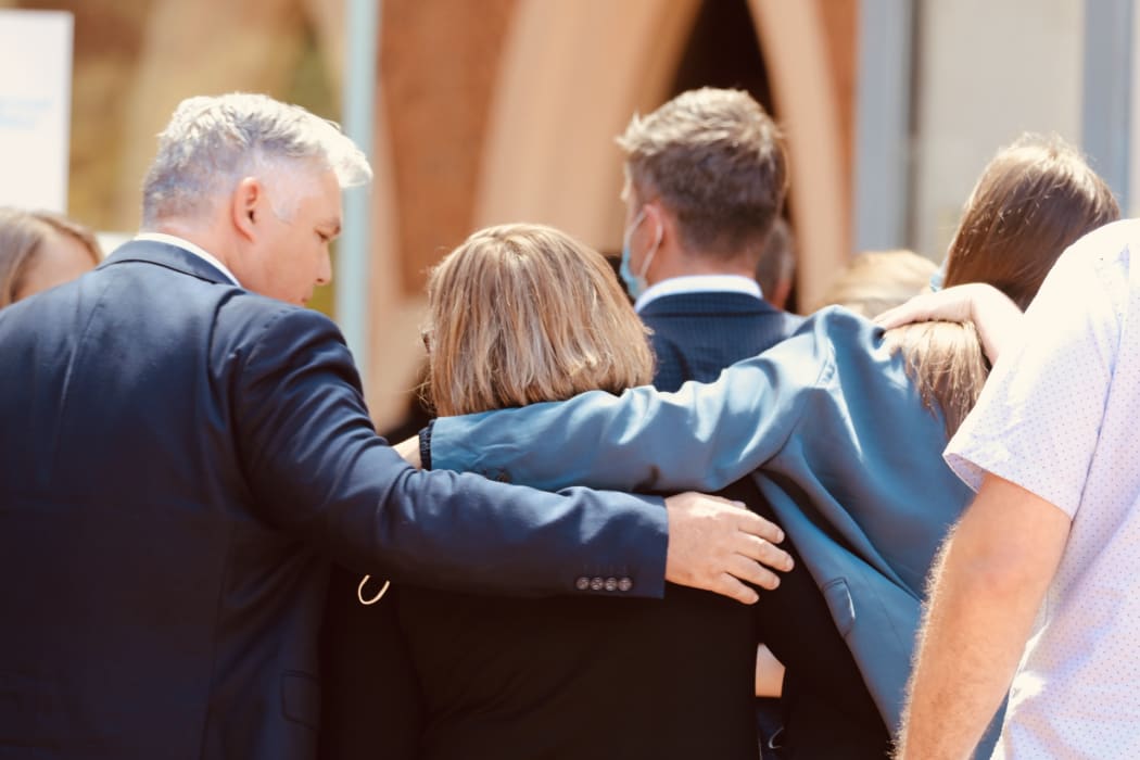 Diane Hunt, mother of slain police officer Matthew Hunt, centre, is supported by family after speaking outside court where her son's killer was sentenced.