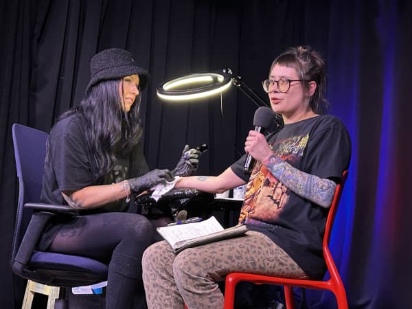 Anya Rzhevitskaya mid-set, being tattooed by Pearl Watson (@mxpxw).