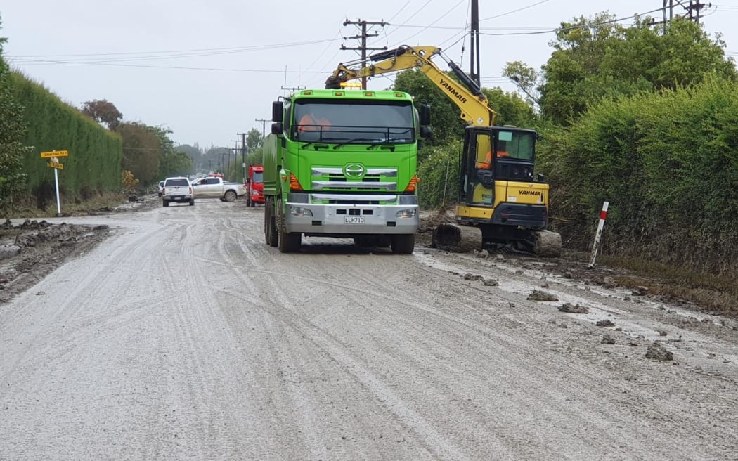Scooping out silt in the rain in Pakowhai near Napier.
