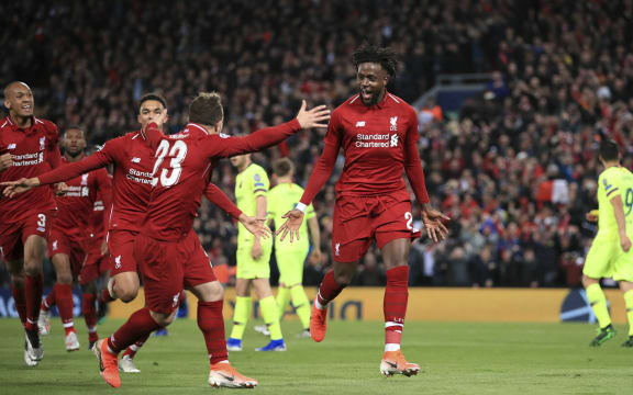 Liverpool's Divock Origi, center, celebrates scoring his side's fourth goal during the Champions League Semi Final between Liverpool and Barcelona at Anfield