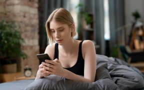 Woman on a cellphone cancelling plans.