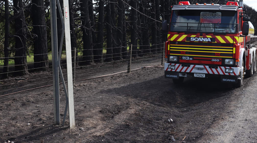 A fire tanker monitors the area of a scrub fire in Fernhill, near Hastings on Wednesday morning after it engulfed trees late last night.