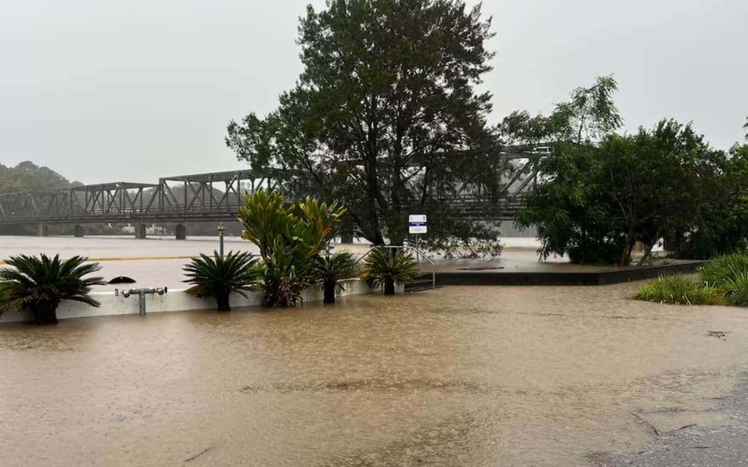 The Macleay River is moving at speed under the Kempsey Bridge.