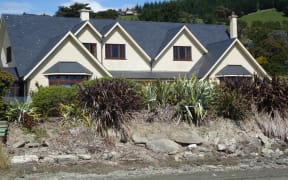 Nelson homeowner Gaire Thompson has been waiting more than a year for council consent for a rock wall.