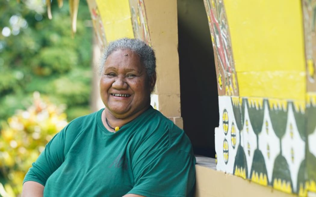 Lelly Obakerbau, the tourism program assistant for Aimeliik state, sits outside a bai, or traditional meeting house, on Nov. 30, 2024 in Palau