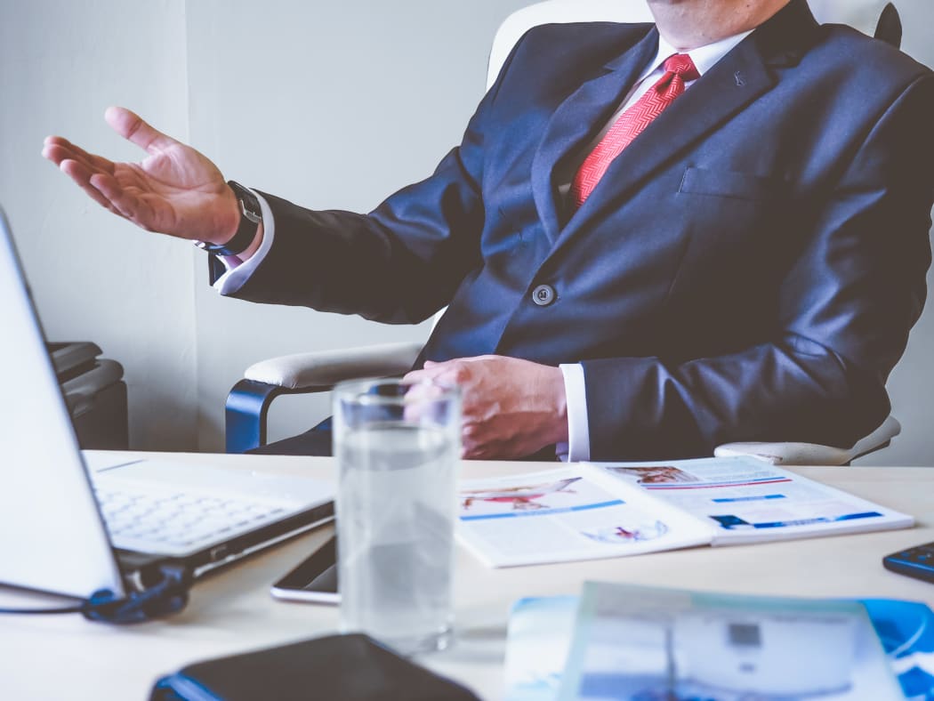 guy in suit gesturing