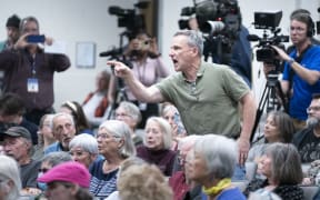 ASHEVILLE, NORTH CAROLINA - MARCH 13: A man shouts at Rep. Chuck Edwards (R-NC) during a congressional town hall meeting on March 13, 2025 in Asheville, North Carolina. The event comes as Republicans have faced protestors at town halls critical of the Trump administration slashing federal jobs.   Sean Rayford/Getty Images/AFP (Photo by Sean Rayford / GETTY IMAGES NORTH AMERICA / Getty Images via AFP)