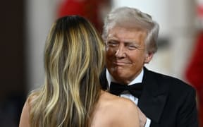 US President Donald Trump (R) and US First Lady Melania Trump dance to The Battle Hymn of the Republic during the Commander-In-Chief inaugural ball at the Walter E. Washington Convention Center in Washington, DC, on January 20, 2025. (Photo by Patrick T. Fallon / AFP)