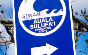 A sign on the beach directs people to the tsunami escape route.