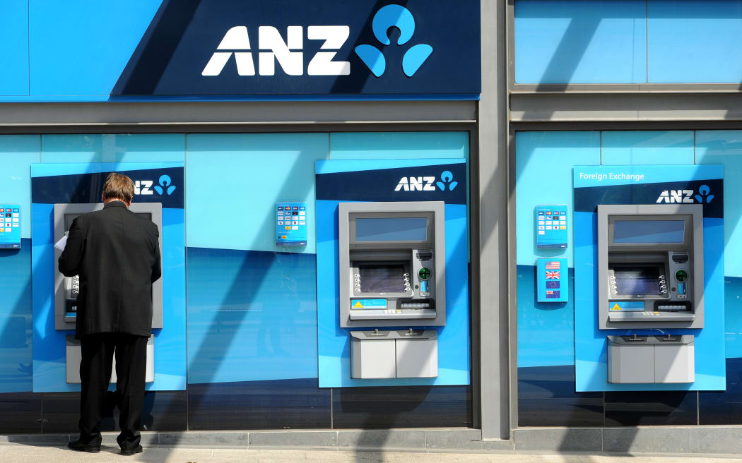 A man withdraws money from an ATM at the global headquarters of the Australia and New Zealand (ANZ) Bank in Melbourne on February, 2012.