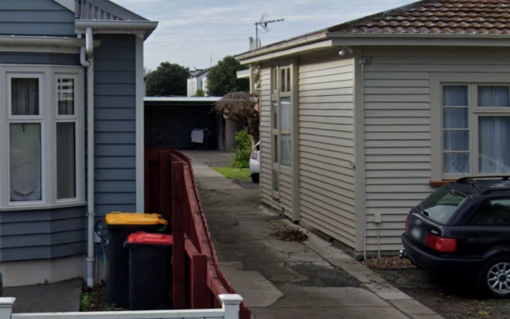 A long driveway with a number of units down it.